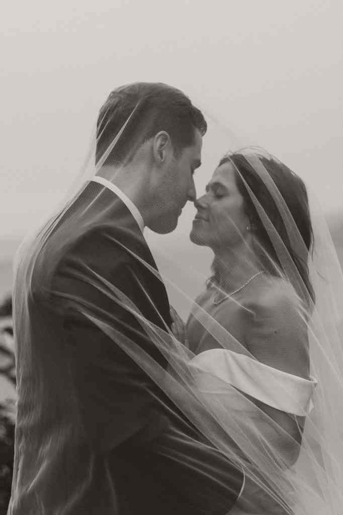 Stunning black and white photo of a couple under a wedding veil in the Okanagan