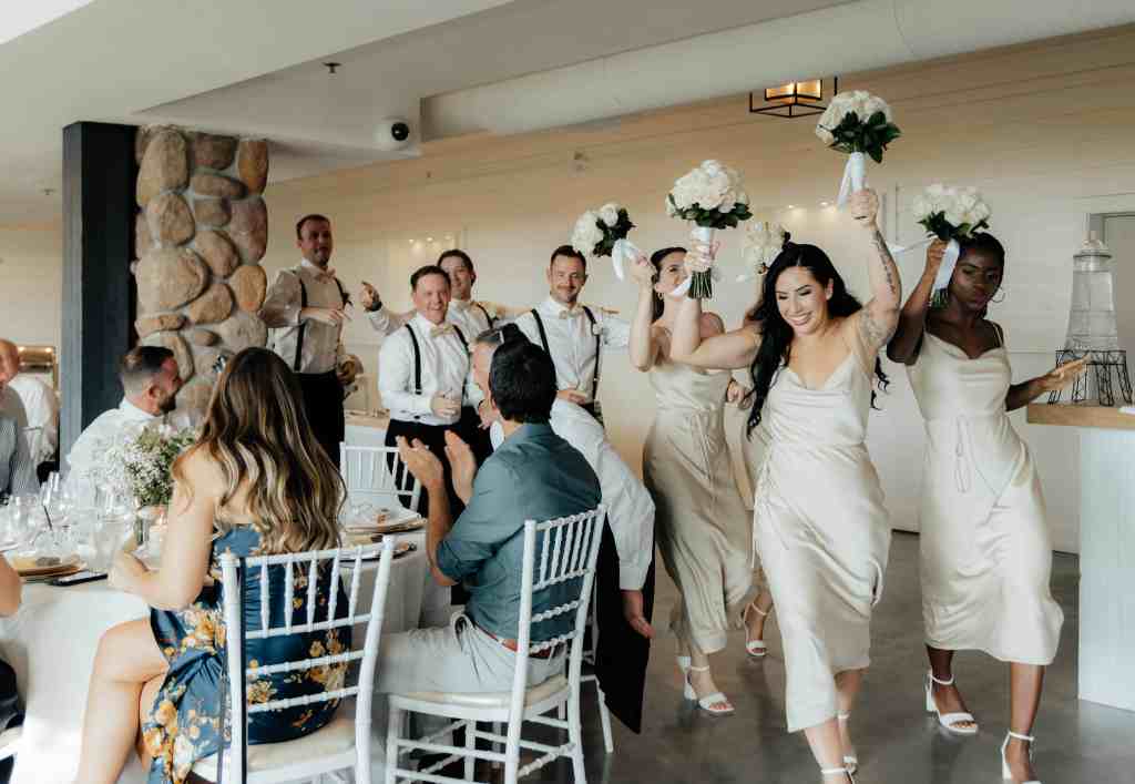Fun wedding party reception entrance at Summerhill Winery, Kelowna captured by wedding photographer Devon Wells