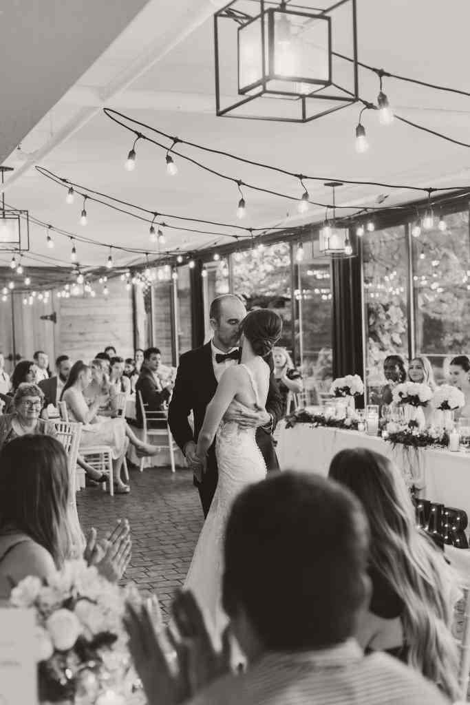 A beautiful black and white shot of a bride and groom's first dance at their wedding reception at Summerhill Winery in the Okanagan