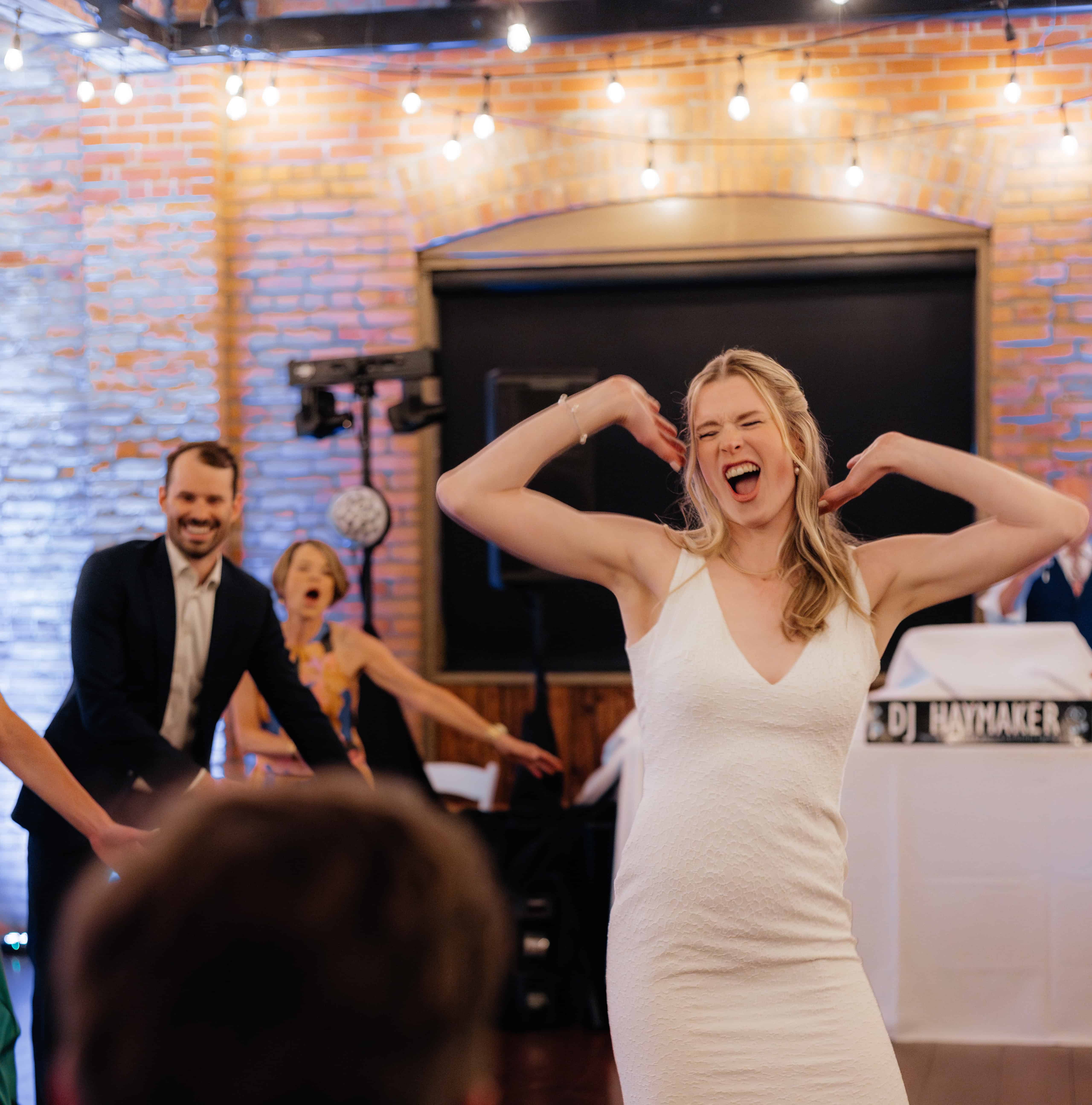 A bride does a surprise choreographed dance number for her new husband at their wedding reception at the Laurel Packing House in Kelowna.