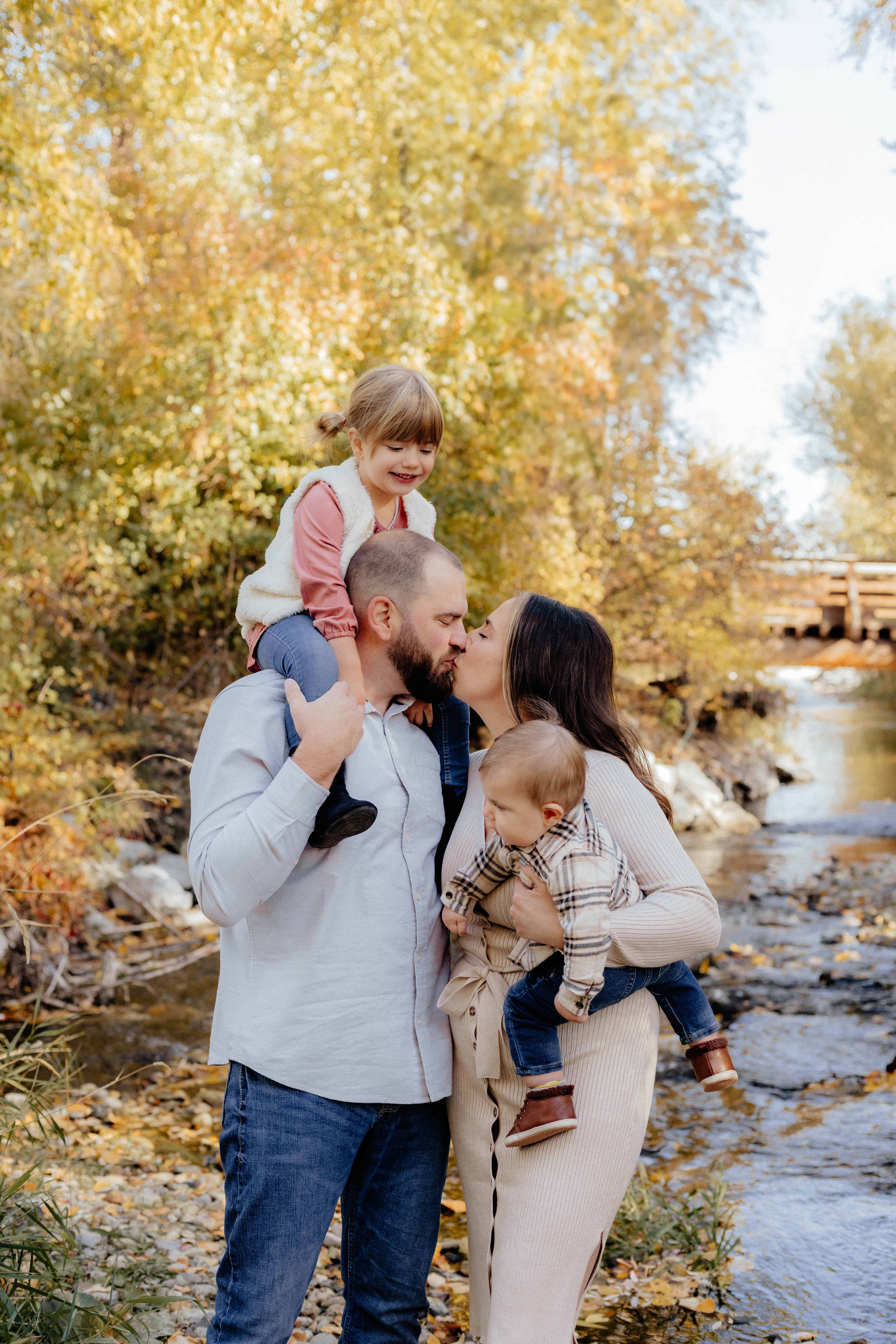 A sweet family poses for a fun photo during a beautiful fall family photo session at Rotary Trails in West Kelowna