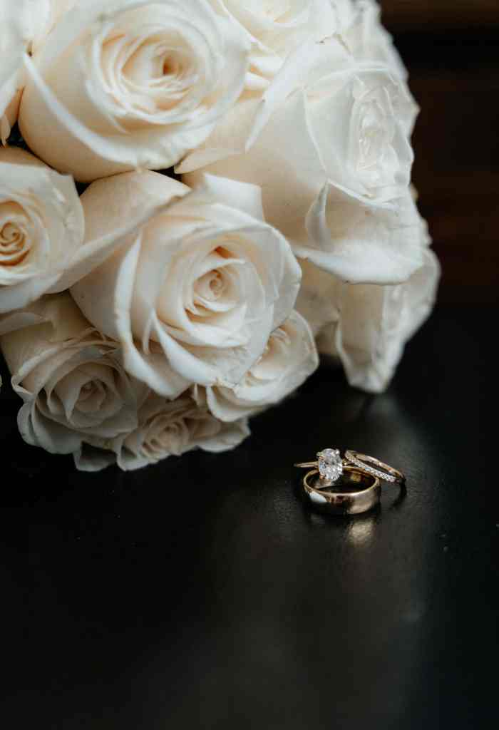 A detail photo of a bridal bouquet and the bride and groom's wedding rings from their wedding in Kelowna, BC