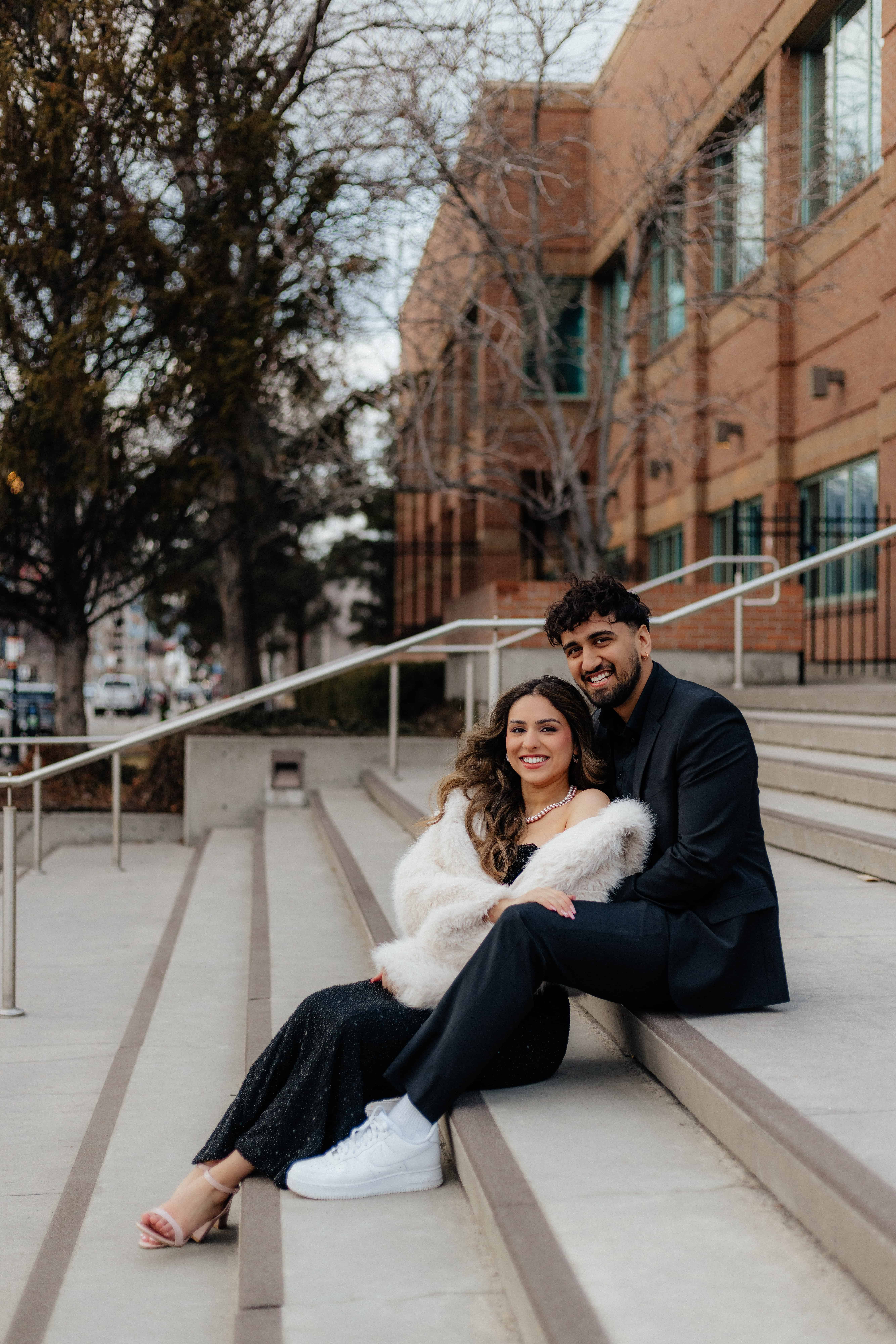 A beautiful couple poses in front of the Kelowna Courts building in downtown Kelowna, Okanagan