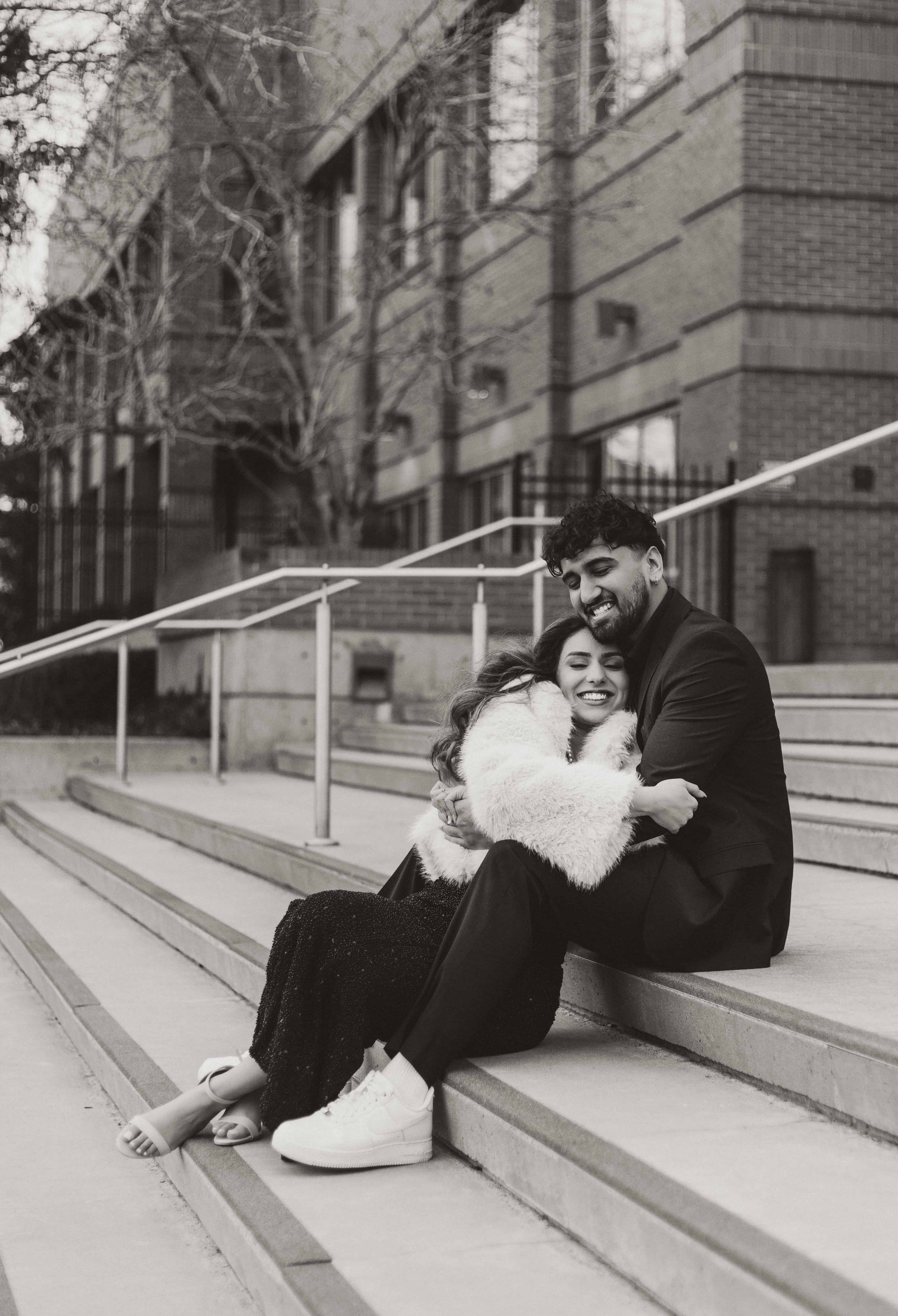 A beautiful couple poses in front of the Kelowna Courts building in downtown Kelowna, Okanagan
