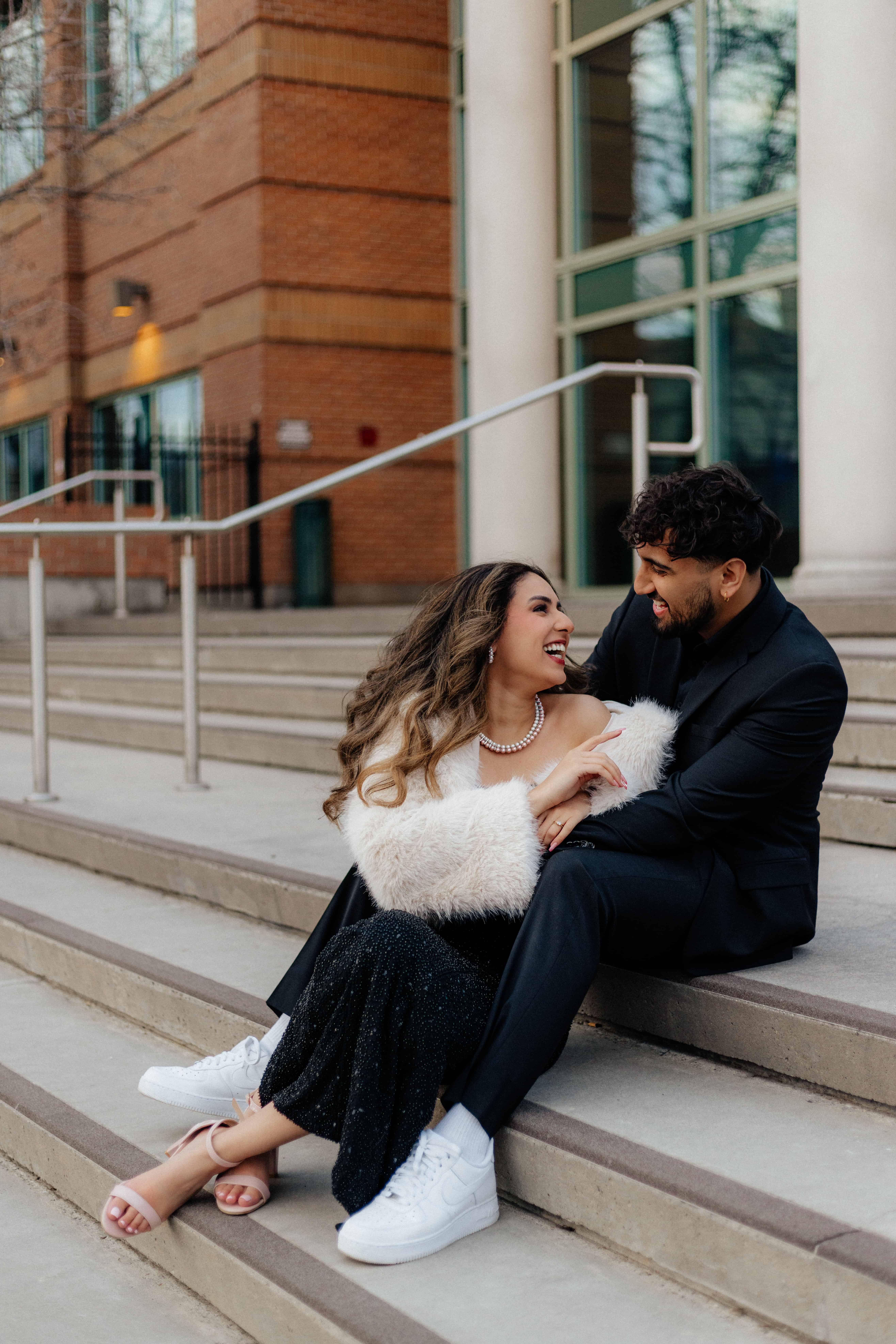 A beautiful couple poses in front of the Kelowna Courts building in downtown Kelowna, Okanagan