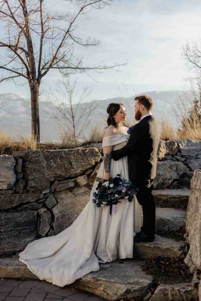 A bride and groom gaze into each other's eyes lovingly in a beautiful golden hour wedding portrait at Sanctuary Gardens, West Kelowna