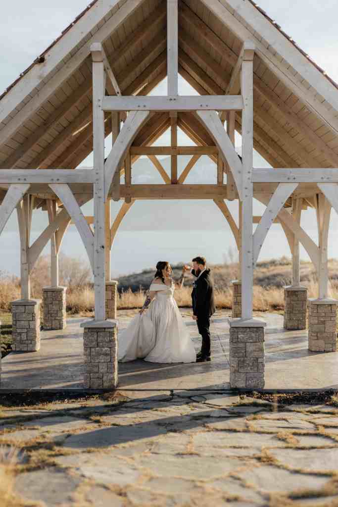 A wedding couple dances at Sanctuary Gardens in West Kelowna in front of Lake Okanagan as the sun sets
