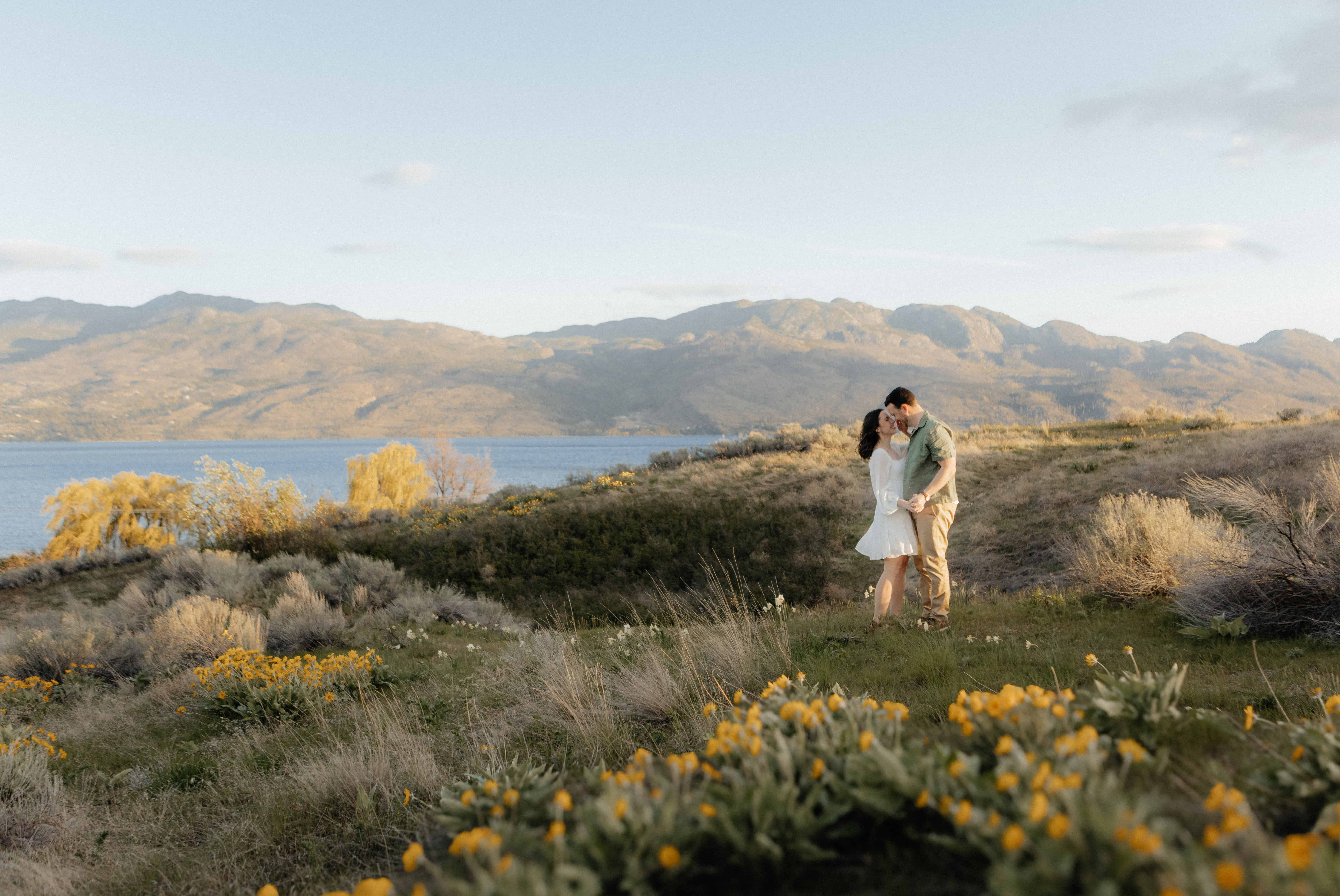 A couple shares an intimate dance at golden hour during their engagement photoshoot in the Okanagan