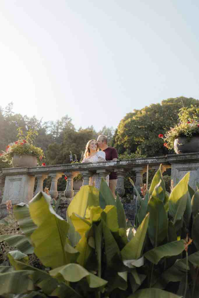 A couple poses during their engagement photoshoot at Hatley Castle in Victoria, BC