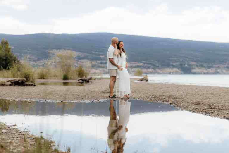 A couple in love poses for a beautiful engagement session shot at Sun-Oka Beach in Summerland, BC