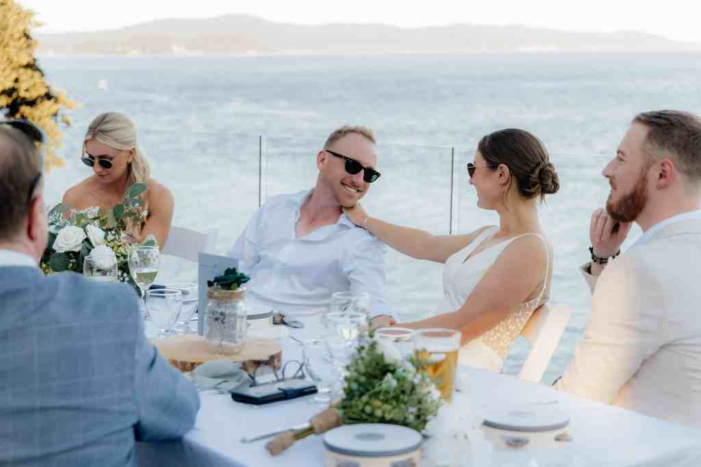 A newlywed couple looks at each other lovingly in a candid photo during their Vancouver Island wedding at the Cove at Otter Point in Sooke, BC